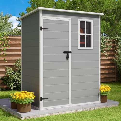 Compact gray garden shed with window and flowers